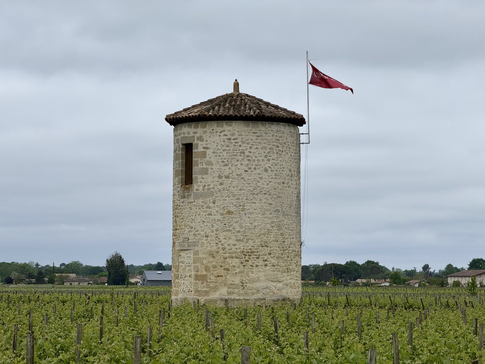 Tower with a flag above the vines, Margaux